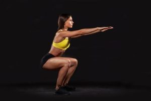 A lady doing squats.